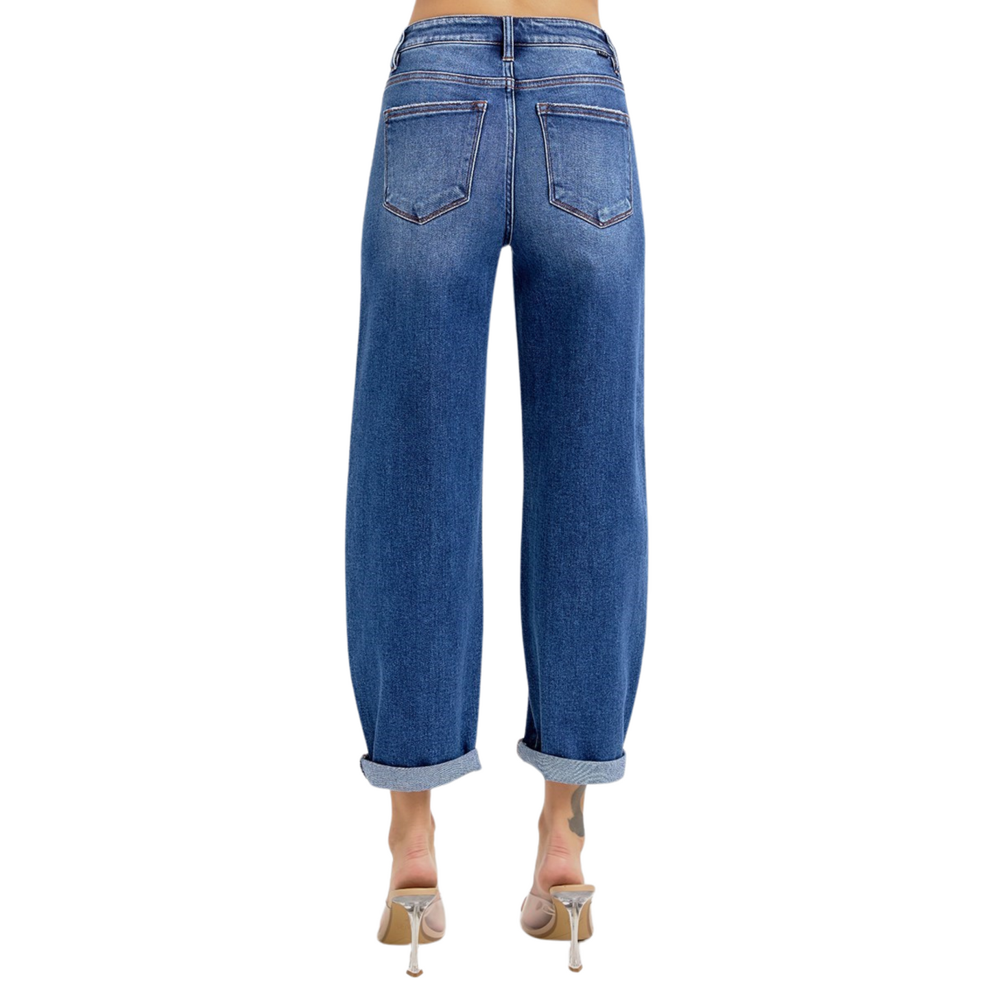 Expertly crafted by Risen, these High Rise Cropped Mild Barrel Jeans boast a flattering cropped length and a bold wide leg design. With a dark wash that adds a touch of sophistication, these jeans offer a comfortable high rise fit, making them the perfect addition to any stylish wardrobe.