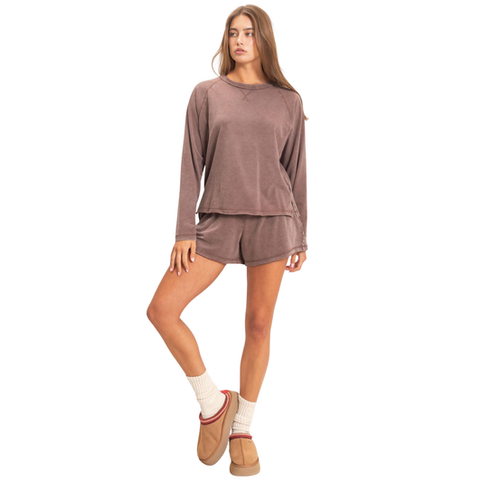 Effortless style meets comfort in this HYFVE mineral washed top and bottom set. The dark brown hue complements any complexion, while the long sleeve top and coordinating shorts create a cohesive, put-together look. Perfect for casual outings, workouts, or relaxing at home. The mineral wash adds a contemporary touch that pairs seamlessly with sneakers or slides.