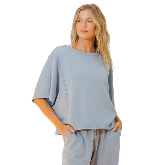 Effortless style meets comfort in this Rae Mode boxy top. The mineral washed finish gives it a relaxed, lived-in aesthetic that pairs perfectly with any casual wardrobe. Cut in a flattering utility blue shade with short sleeves, this piece offers a laid-back silhouette that works for everyday wear. The boxy fit provides ease of movement while maintaining a contemporary look. A versatile essential for creating understated, put-together outfits.