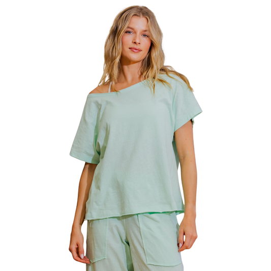 Effortless style meets comfort in this Cotton Slub Off-The-Shoulder Tee by Rae Mode. The soft, textured cotton slub fabric drapes beautifully, while the one-shoulder design adds a modern, flattering touch. In a soothing mint color, this versatile piece transitions seamlessly from casual days to evening outings. Perfect for layering or wearing solo, it's a wardrobe essential that combines contemporary flair with everyday wearability.