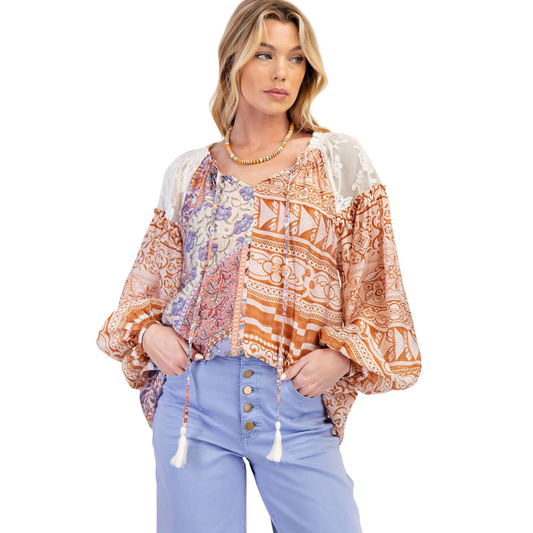 Elevate your wardrobe with the Mixed Print Loose Blouse by Easel. This long-sleeve top features a relaxed, loose fit for comfort and effortless style. Expertly designed with intricate lace accents and a vibrant multicolor print, it offers a sophisticated yet casual look perfect for day-to-night wear. Ideal for those seeking a blend of elegance and ease in their everyday outfits.