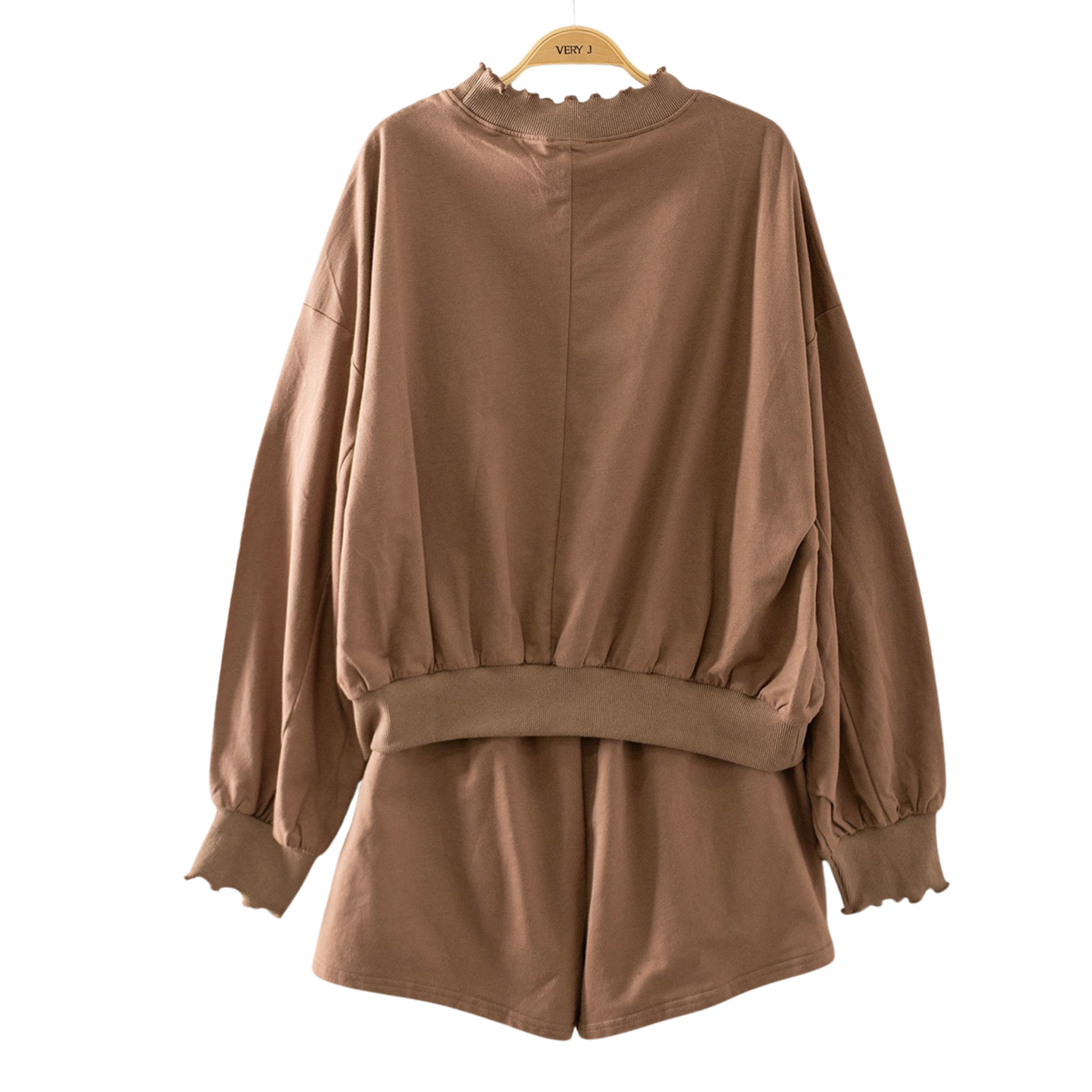 Cozy up in style with this elegant loungewear set by Very J. The mocha-colored long sleeve sweatshirt features delicate lace trimming for a touch of sophistication, while the matching drawstring shorts offer comfortable, relaxed fit. Perfect for lazy days at home or casual outings, this two-piece set combines comfort with understated elegance. The soft fabric and thoughtful design make it an ideal choice for unwinding in style.