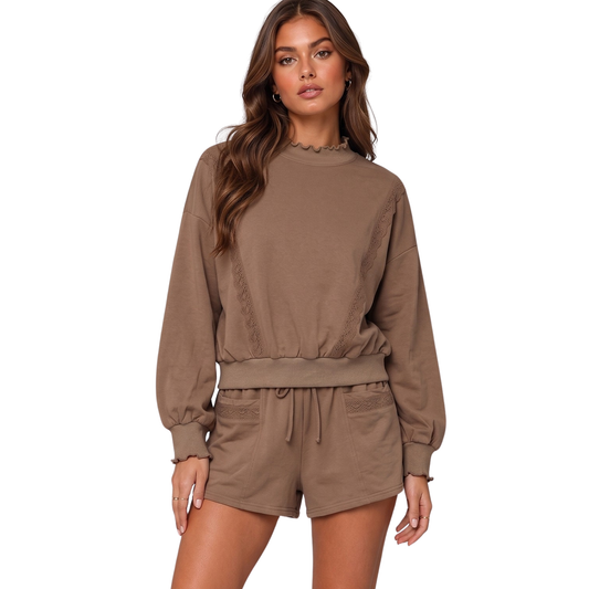Cozy up in style with this elegant loungewear set by Very J. The mocha-colored long sleeve sweatshirt features delicate lace trimming for a touch of sophistication, while the matching drawstring shorts offer comfortable, relaxed fit. Perfect for lazy days at home or casual outings, this two-piece set combines comfort with understated elegance. The soft fabric and thoughtful design make it an ideal choice for unwinding in style.