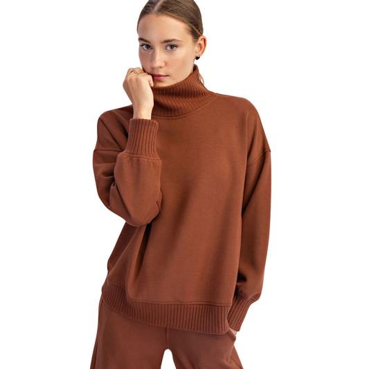 Modal Scuba Pullover and Pants Set by Rae Mode combines comfort with contemporary style. This chestnut-hued ensemble features a long-sleeve pullover with a refined mock neck, paired with coordinating pants for a polished, put-together look. Crafted from modal fabric, the set delivers a soft, breathable feel ideal for layering or wearing solo. Perfect for transitional seasons or casual everyday wear, this outfit set offers effortless sophistication without compromising on comfort.