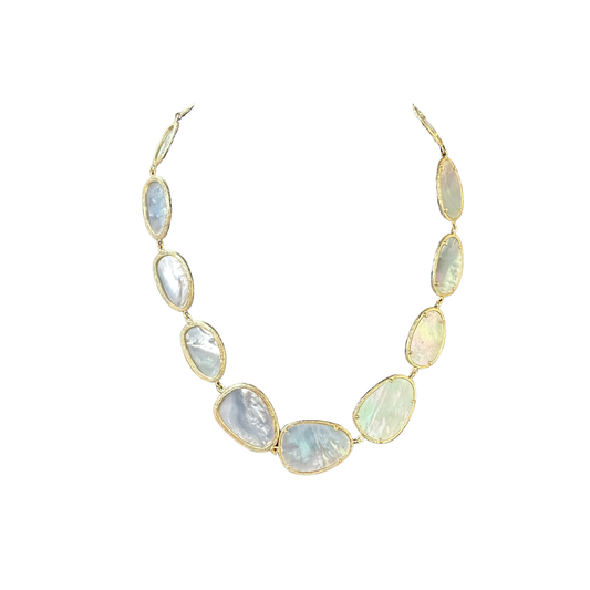 Elegant short necklace featuring a lustrous mother of pearl accent. The iridescent shell element catches light beautifully, adding a sophisticated touch to any outfit. Perfect for layering or wearing alone, this piece combines timeless style with natural beauty. Gold-toned hardware complements the pearl's soft shimmer for a refined, versatile look.