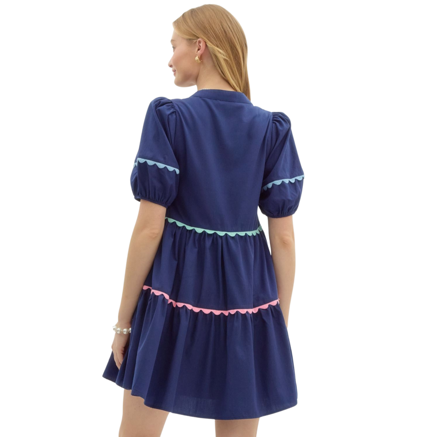 Experience comfort and style with our Entro Babydoll Pullover Mini Dress. Featuring a solid color and short lantern sleeves, this dress also includes pockets and multicolor scallop accent trims. Lined and lightweight, it's perfect for any occasion. Non-sheer and easy to wear, get yours in navy today.