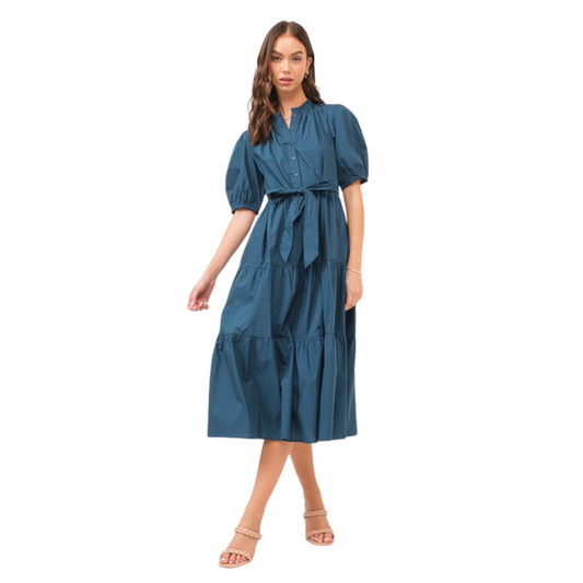 Expertly crafted from sleek navy fabric, this Tiered Midi Dress is the epitome of understated elegance. With its midi length and v-neck design, it flatters every figure. The belted waist cinches to accentuate your curves, while the short sleeves provide versatile styling options. Perfect for any occasion, this dress is a must-have for every wardrobe.