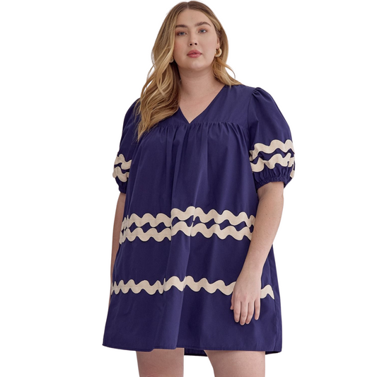 With its solid v-neck design and rick rack trimming detail, this navy half sleeve mini dress is both stylish and functional. The addition of pockets on the side adds convenience, while the lightweight and non-sheer woven fabric makes it a comfortable and versatile option for any occasion. Perfect for a day out in the sun or a night on the town.