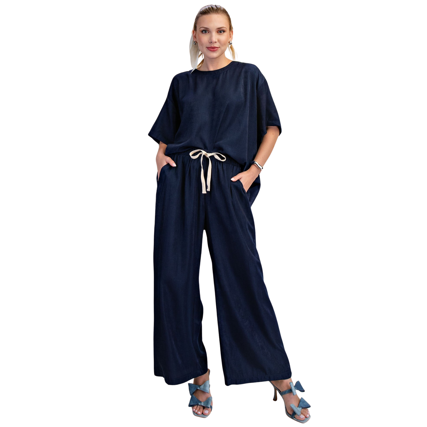 Elevate your everyday style with this chic Glam brand two-piece set. The oversized navy round neck top features comfortable short sleeves, perfectly paired with matching wide leg pants for an effortlessly polished look. Ideal for casual outings or relaxed workdays, this set combines comfort and contemporary fashion in one coordinated ensemble.