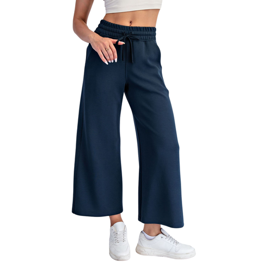Elevate your casual wardrobe with these Modal Scuba Wide Leg Pants from Rae Mode. Crafted in navy with a comfortable elastic waist, they offer effortless style and all-day comfort. The relaxed wide-leg silhouette provides a flattering fit perfect for lounging or running errands. Lightweight modal fabric moves with you while maintaining its shape. A versatile staple that pairs easily with any top.