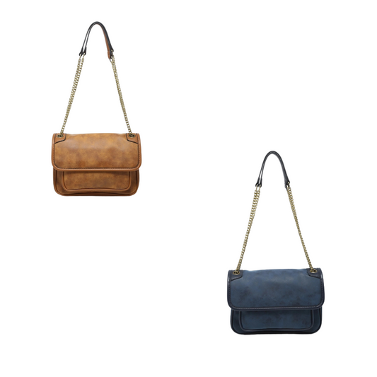 Crafted from premium suede, the Nola Convertible Crossbody Bag by Jen &amp; Co offers versatile elegance in navy and tan. Its convertible design allows seamless transition from crossbody to shoulder style, providing both comfort and functionality. Ideal for those seeking a refined accessory that complements a variety of outfits while ensuring hands-free convenience.