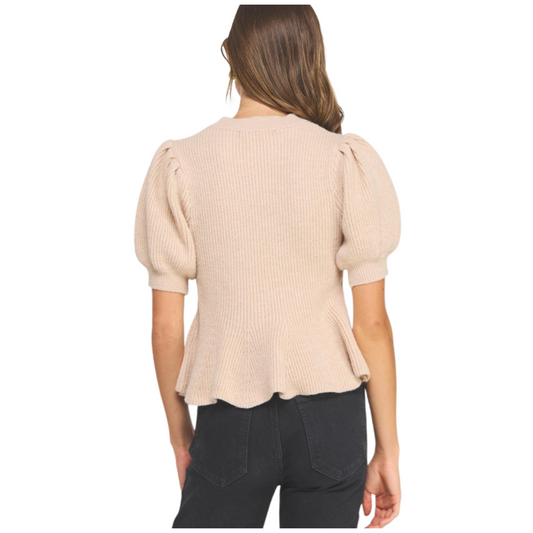 This Flared Puff Sleeve Top from Strut &amp; Bolt showcases a refined oatmeal knit fabric, offering both comfort and subtle texture. Its short sleeves feature a distinct puff design that adds volume and a contemporary flair, while the flared silhouette enhances movement and creates a flattering shape. Ideal for elevating casual looks with a sophisticated edge, this top combines stylish details with expert craftsmanship for versatile everyday wear.