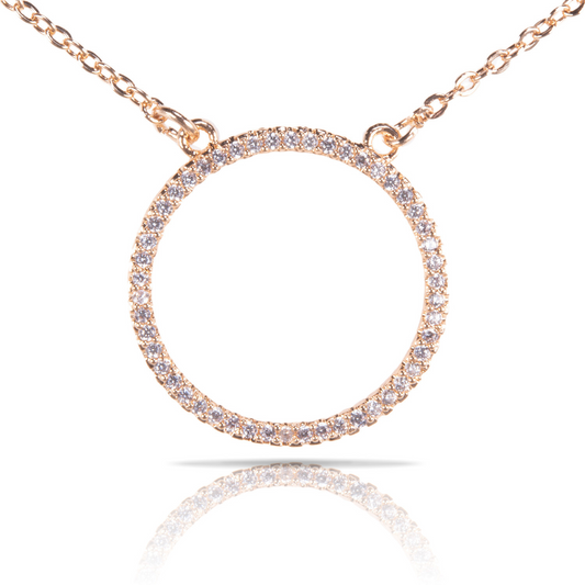 This gold open circle necklace features a short design and sparkling rhinestone accents. Crafted with attention to detail, this piece exudes elegance and sophistication, making it the perfect accessory for any outfit. The open circle design adds a touch of modernity, while the gold finish adds a timeless appeal. Elevate your style with this stunning necklace.