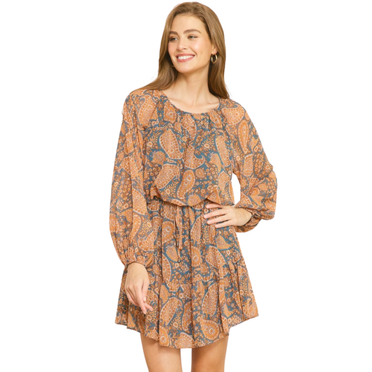 Stand out with style in this Long Sleeve Paisley Print Mini Dress. It features a unique paisley print, boat neckline, long sleeves with elastic cuffs, and front buttons. The self-tie at the waist and lightweight woven fabric provide a flattering fit. This dress is fully lined for added comfort.