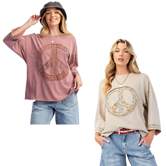 This Half Sleeve Peace Sign Top by Easel features 3/4 length sleeves for comfortable coverage and a distinctive peace sign patchwork that adds a subtle, stylish statement. Available in mauve and beige, this piece blends casual elegance with a touch of retro flair, making it a versatile addition to any wardrobe. Its design balances comfort and unique detail, ideal for those seeking both style and ease in their everyday wear.