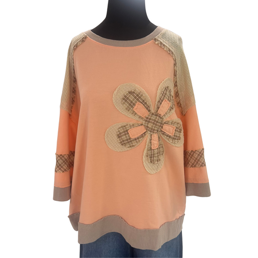 Elevate your wardrobe with this Flower Patch Detail Top by Easel. Featuring a rich peach coral hue and long sleeves, it offers both warmth and style. The delicate flower patch accent adds a refined touch, creating a sophisticated yet approachable look perfect for layering or wearing on its own. Crafted for comfort and elegance, this top seamlessly blends artistry with everyday wear.