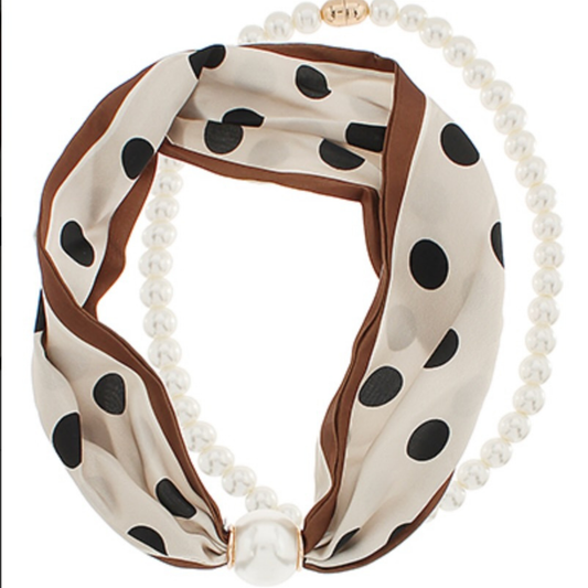 Elevate your accessory game with this stunning scarf necklace from Golden Stella. Crafted in soft beige and rich brown tones, it features playful black polka dots throughout for a timeless, versatile look. Delicate pearl accents add sophistication, while the secure magnetic pearl closure ensures easy on-and-off wear. Perfect for layering or wearing solo, this piece transitions seamlessly from casual to dressy occasions. 