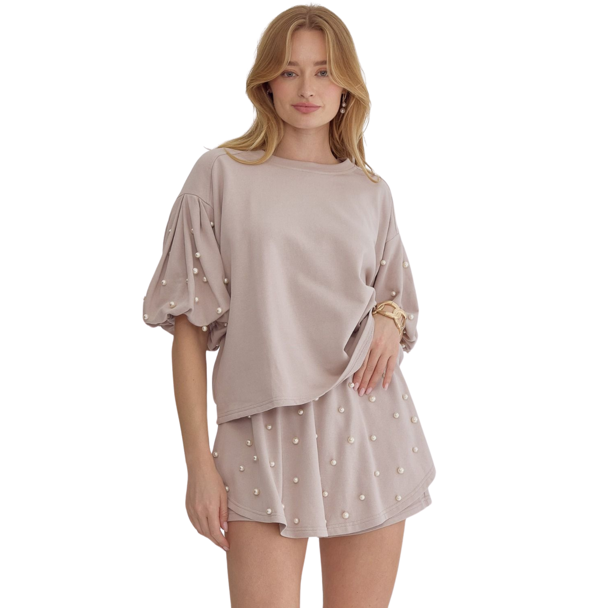 This cotton pearl accented short set in light mocha offers a comfortable and stylish option for your summer wardrobe. Made with high-quality cotton, the set features delicate pearl accents, adding a touch of elegance to your casual look. Perfect for a day out or lounging at home.