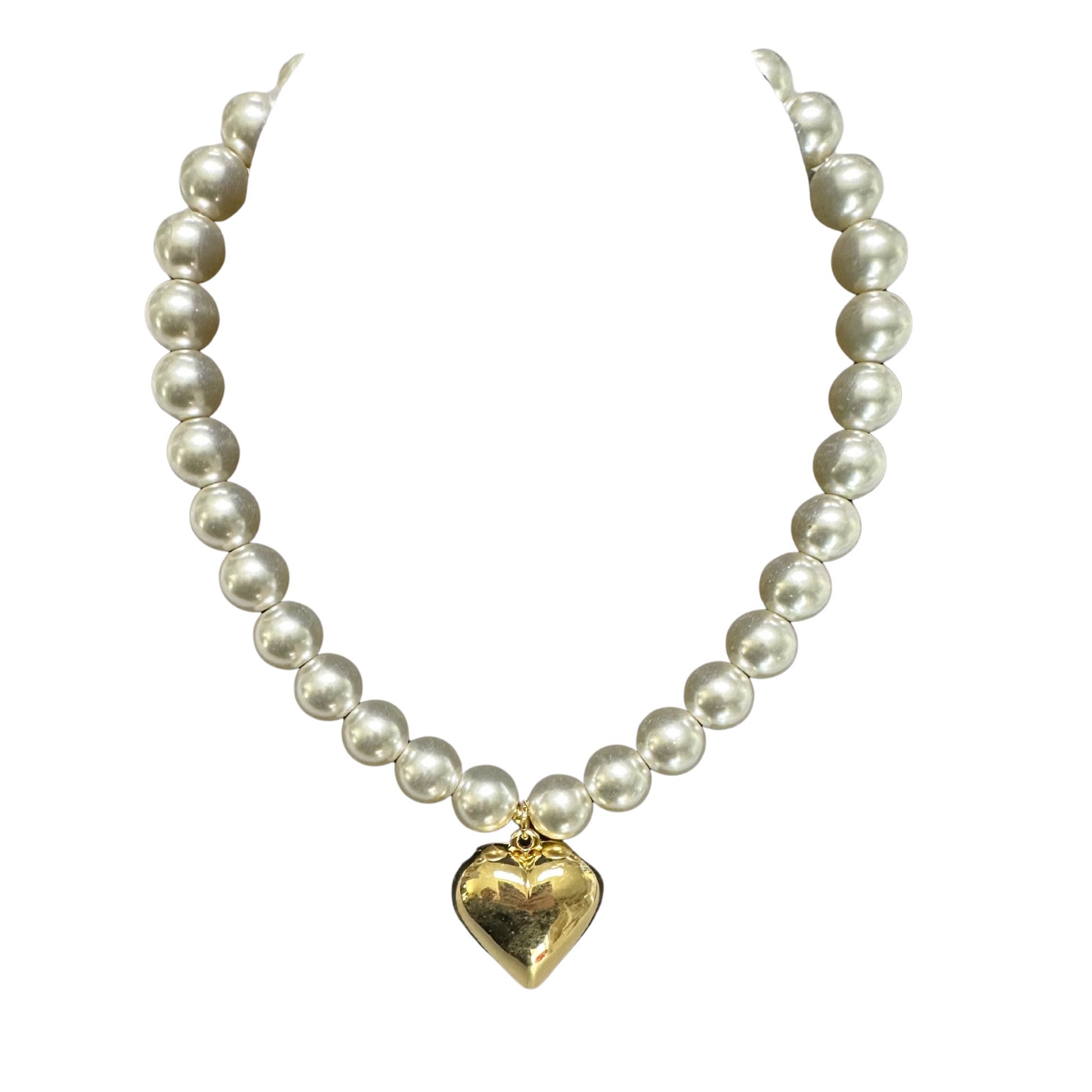 Elevate your everyday elegance with this exquisite Pearl Heart Necklace from Perdido Gems. Featuring a lustrous gold heart pendant suspended from a delicate short chain, this piece seamlessly transitions from casual to formal occasions. The timeless combination of pearl accents and warm gold tones creates a sophisticated aesthetic that complements any complexion. Perfect for layering or wearing solo, this necklace offers versatile styling options for the discerning jewelry collector. A refined addition to y