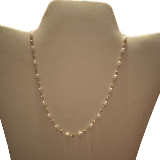 The Small Pearl Necklace by Crystal Avenue is a perfect blend of elegance and simplicity. Crafted with a dainty gold chain, this necklace features beautiful pearl accents that add a touch of sophistication to any outfit. Its shorter length makes it versatile and perfect for any occasion.