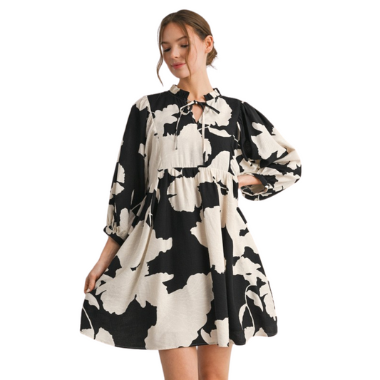 This Jodifl Loose Fit Peasant Dress features an eye-catching black and white abstract print that elevates its modern appeal. Designed with a tie-front detail, it offers adjustable styling and a flattering silhouette. Its mini length and relaxed fit provide comfort and effortless movement, making it a versatile choice for both casual outings and stylish events. Crafted for ease and impact, this dress combines contemporary design with timeless comfort.
