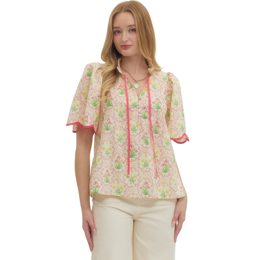 Elevate your wardrobe with this charming Pink Floral Top by Entro. Featuring a delicate floral print in soft pink tones, this piece brings effortless femininity to any outfit. The short sleeves offer comfortable everyday wear, while decorative button accents add a touch of sophistication. A scalloped hem creates a refined, polished finish that flatters the silhouette. Perfect for casual outings, brunch, or layering under your favorite jacket. 