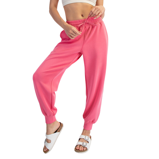 Elevate your loungewear collection with these Modal Scuba Joggers from Rae Mode. Crafted in a vibrant bright pink, these joggers combine comfort with contemporary style. The elastic waist and adjustable drawstring provide a customizable fit, while the soft modal-scuba blend fabric offers breathability and ease of movement. Perfect for relaxing at home, running errands, or casual outings. The jogger silhouette flatters while maintaining that effortless, laid-back vibe you're looking for.