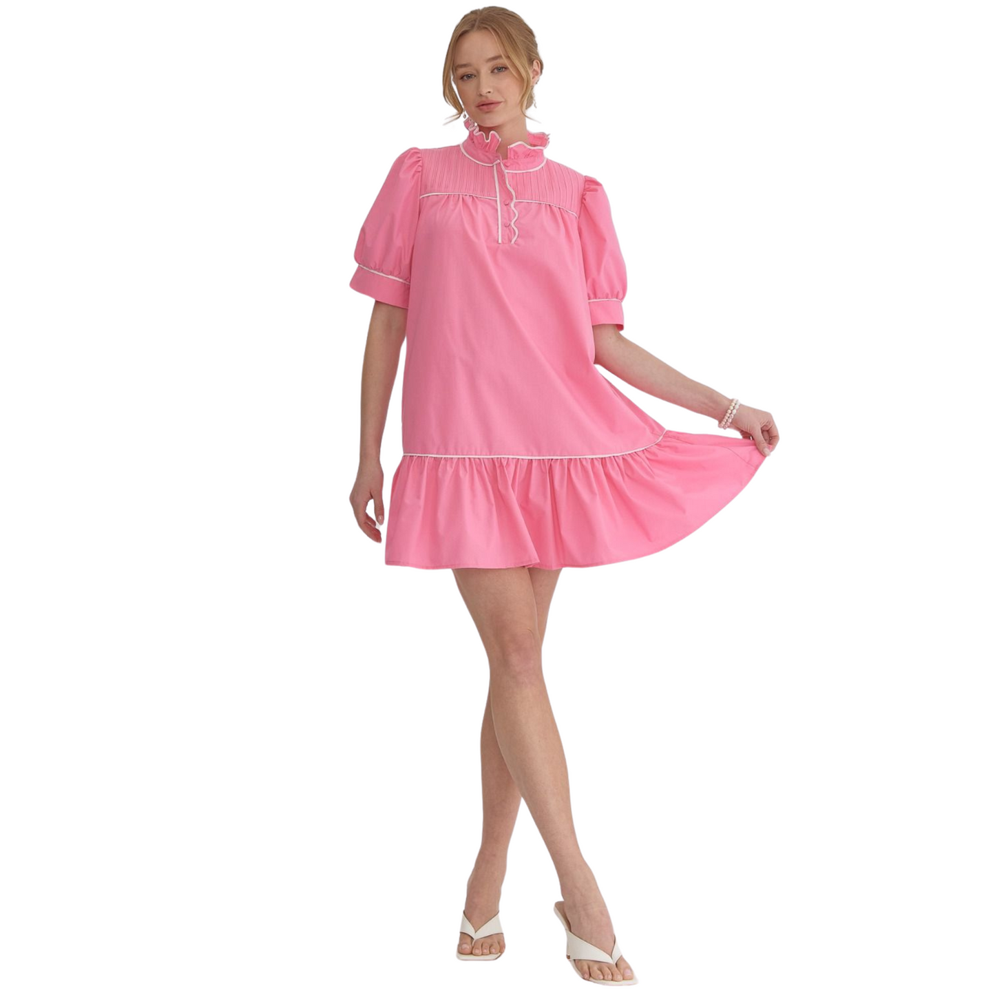 This solid high neck mini dress features a unique ruffled neckline and button up detail at the front. With convenient side pockets and a lightweight, non-sheer woven fabric, this dress is both stylish and practical. Its solid trim and lined design add extra sophistication.