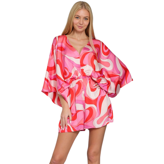 The Kimono Sleeve Romper features elegant kimono sleeves, a flattering tie back, and a comfortable elastic waist. This versatile piece is perfect for any occasion and comes in a beautiful pink/multicolor pattern. Elevate your style with this must-have wardrobe staple.