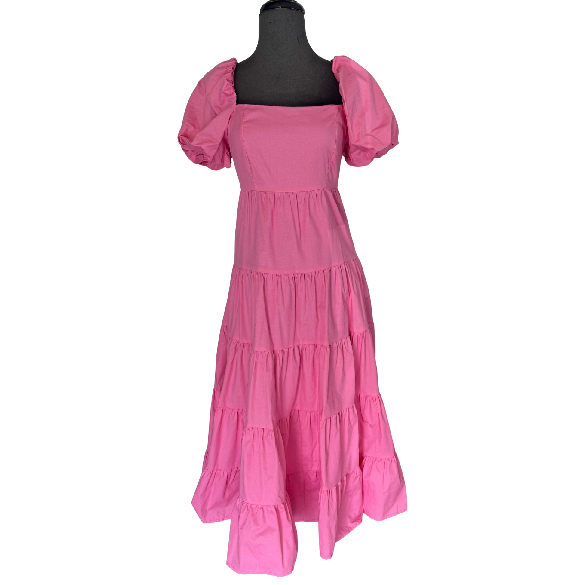 This Tiered Maxi Dress features a beautiful barbie pink color, perfect for making a statement. The tiered design and bubble sleeves add dimension and a feminine touch to the dress. Elevate your wardrobe with this stylish and flattering choice.