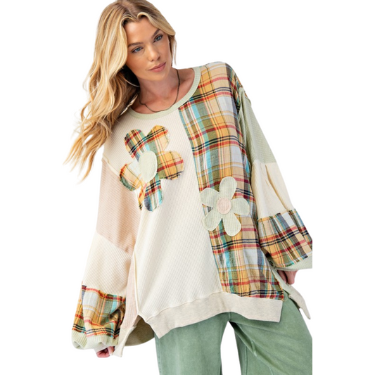 Expertly crafted with a thermal knit fabric, our Plaid Mix Oversized Top features bubble sleeves, a rounded neckline, and ribbed band cuffs for a relaxed and oversized fit. The raised front flower patches and raw cut seams add a touch of unique detailing, while the side slits and color block plaid pattern provide both style and comfort. Made for all sizes.