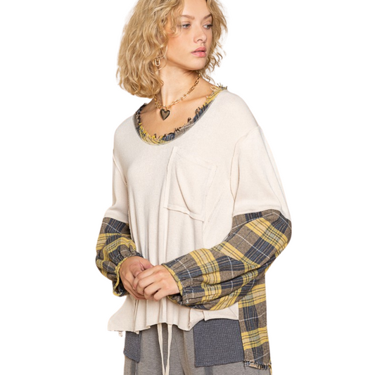 This Plaid Sleeve Pocket Top features a classic blue and yellow plaid on the sleeves and a creamy ivory color on the body. It's made of breathable fabric, ensuring a comfortable fit that's perfect for everyday wear. The pocket adds an extra touch of style that makes this top great for both casual and dressy occasions.