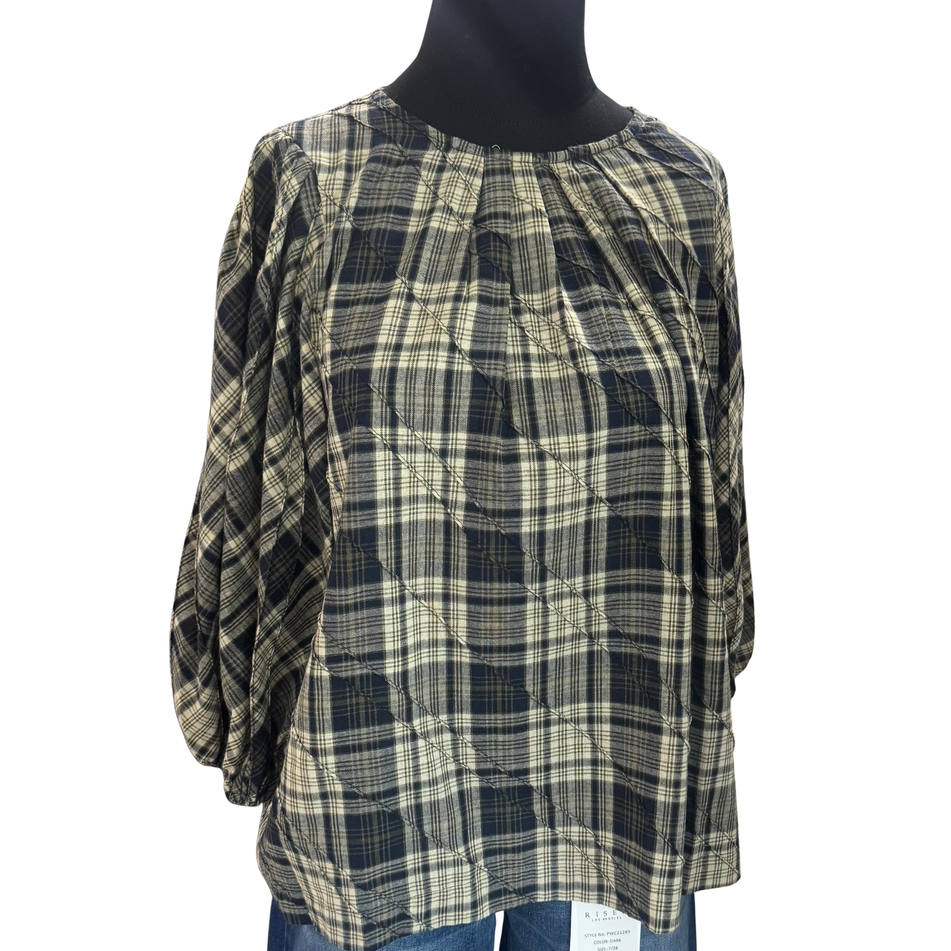This navy plaid top from GiGio combines classic patterning with modern style, featuring pleated details that add texture and sophistication. Its 3/4 length sleeves offer a versatile fit for layering or standalone wear, making it ideal for both professional and casual settings. The tailored design provides a polished look while ensuring comfort throughout the day.