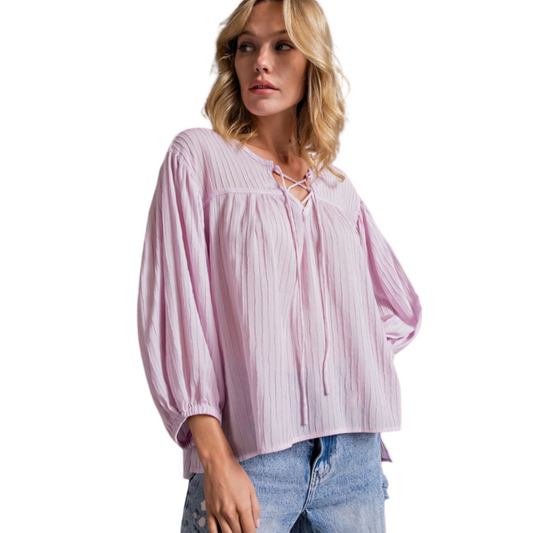 Introducing the Pleated Loose Fit Top: a stylish and breathable look that flaunts a tie-front and pink ribbed material. Enjoy maximum mobility without compromising on comfort!