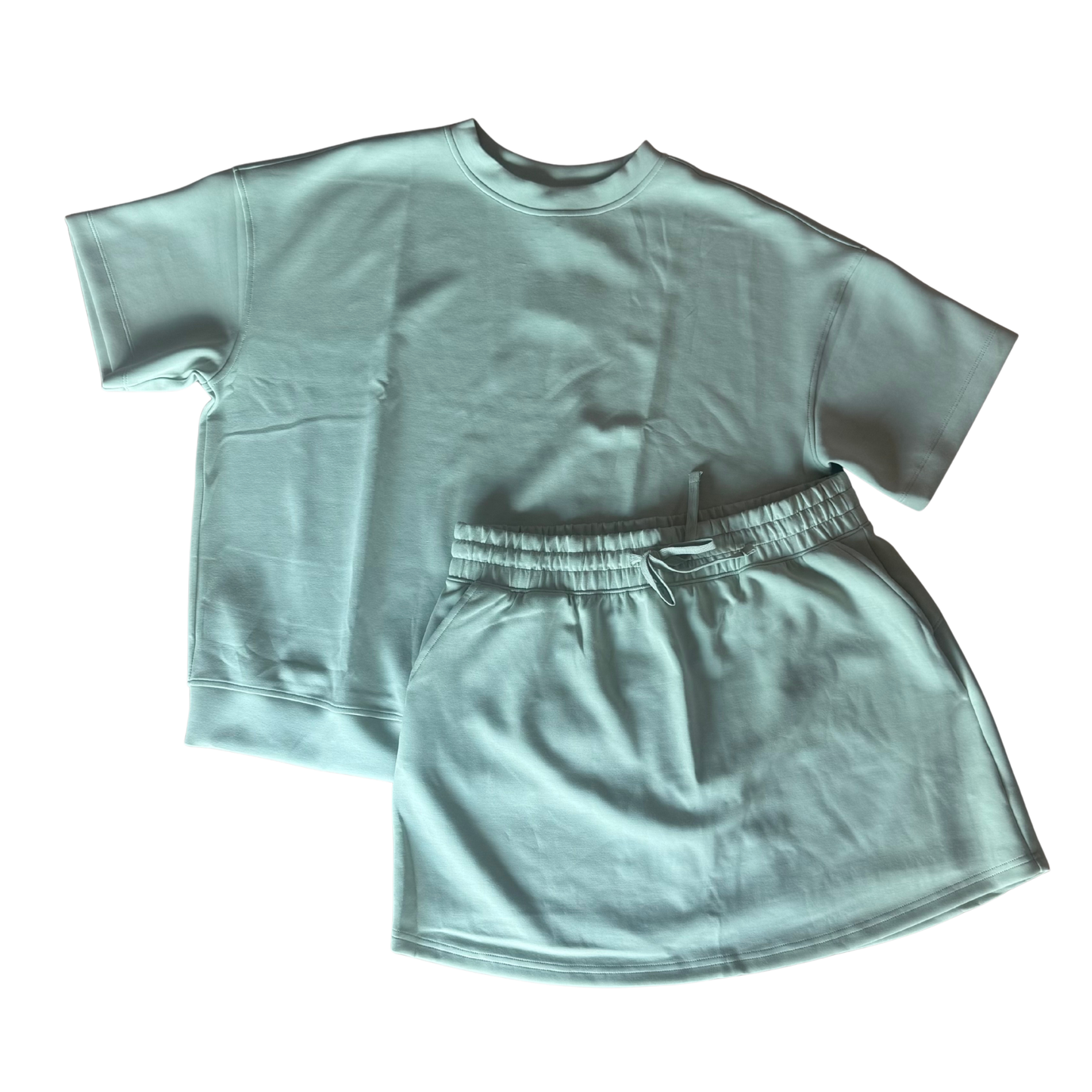 Elevate your casual wardrobe with this effortless two-piece set from Rae Mode. The soft pistachio cream short sleeve top pairs perfectly with a comfortable drawstring skort, creating a versatile look for everyday wear. Designed with plus-size fit in mind, this set offers relaxed styling and breathable comfort. The coordinated pieces work together seamlessly or can be mixed and matched with your existing pieces for endless outfit possibilities.