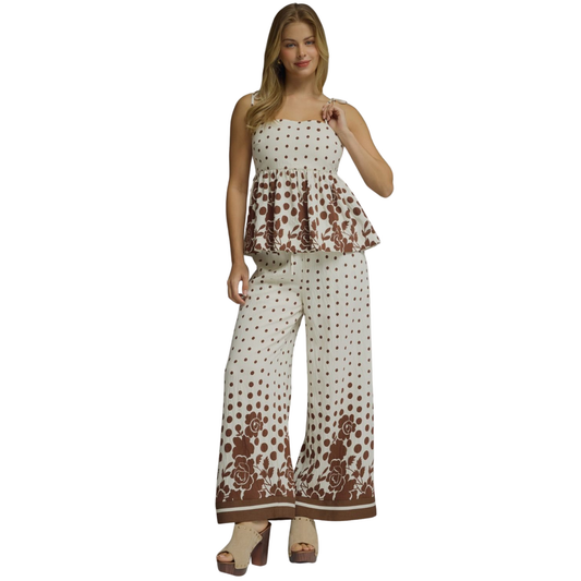 Effortless style meets comfort in this charming Entro polka dot set. The coordinated top and bottom feature delicate spaghetti straps and a timeless brown and ecru color palette that pairs beautifully with any wardrobe. Perfect for casual outings, weekend brunches, or relaxed evenings. The polka dot pattern adds playful sophistication while the lightweight fabric keeps you cool and comfortable all day long.