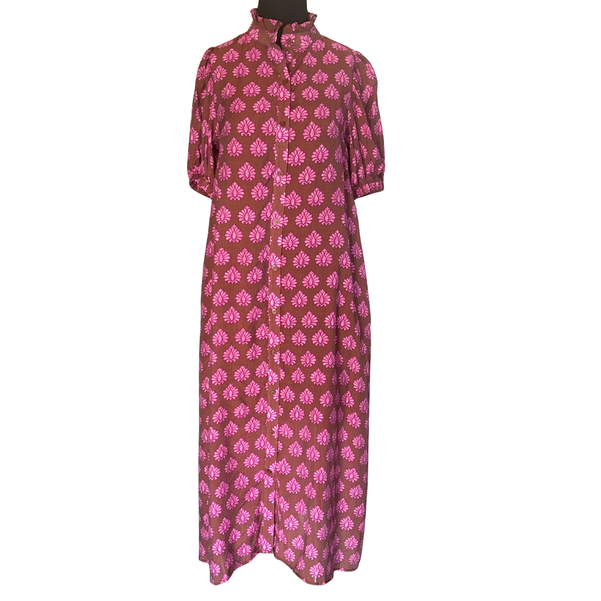 Elevate your wardrobe with this Gigio printed button-down midi dress, designed for the discerning woman. The rich brown mix print offers versatile styling potential, while the charming ruffled collar adds a refined touch of sophistication. Elastic band arms provide comfortable, flattering support throughout the day. Perfect for transitional seasons, this midi silhouette strikes the ideal balance between polished and effortless, making it an essential piece for any occasion-ready closet.