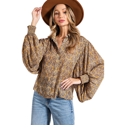 Our Printed Puff Sleeve Blouse is designed for comfortable style in plus sizes. Featuring a V-neck and collared neckline, this blouse also features long, puff sleeves for added style. Perfect for any occasion, it's the perfect addition to any wardrobe.