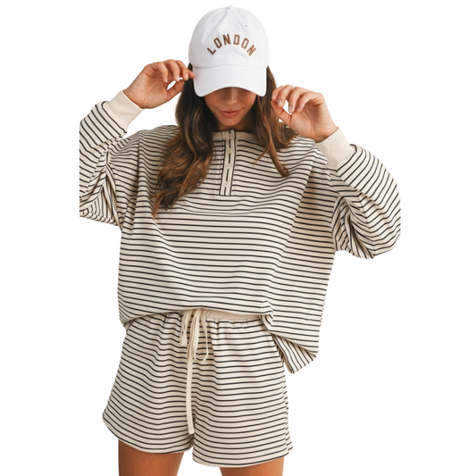 Discover effortless style with the Annie Wear Pin Stripe Pullover &amp; Shorts Set in ivory. This coordinated two-piece features a long sleeve pullover and matching shorts, both showcasing a refined pin stripe pattern. The ivory tone offers a clean, versatile base that pairs easily with your existing wardrobe. Crafted for comfort and sophistication, this set transitions seamlessly from casual days to relaxed evenings, making it a wardrobe essential for the modern lifestyle.