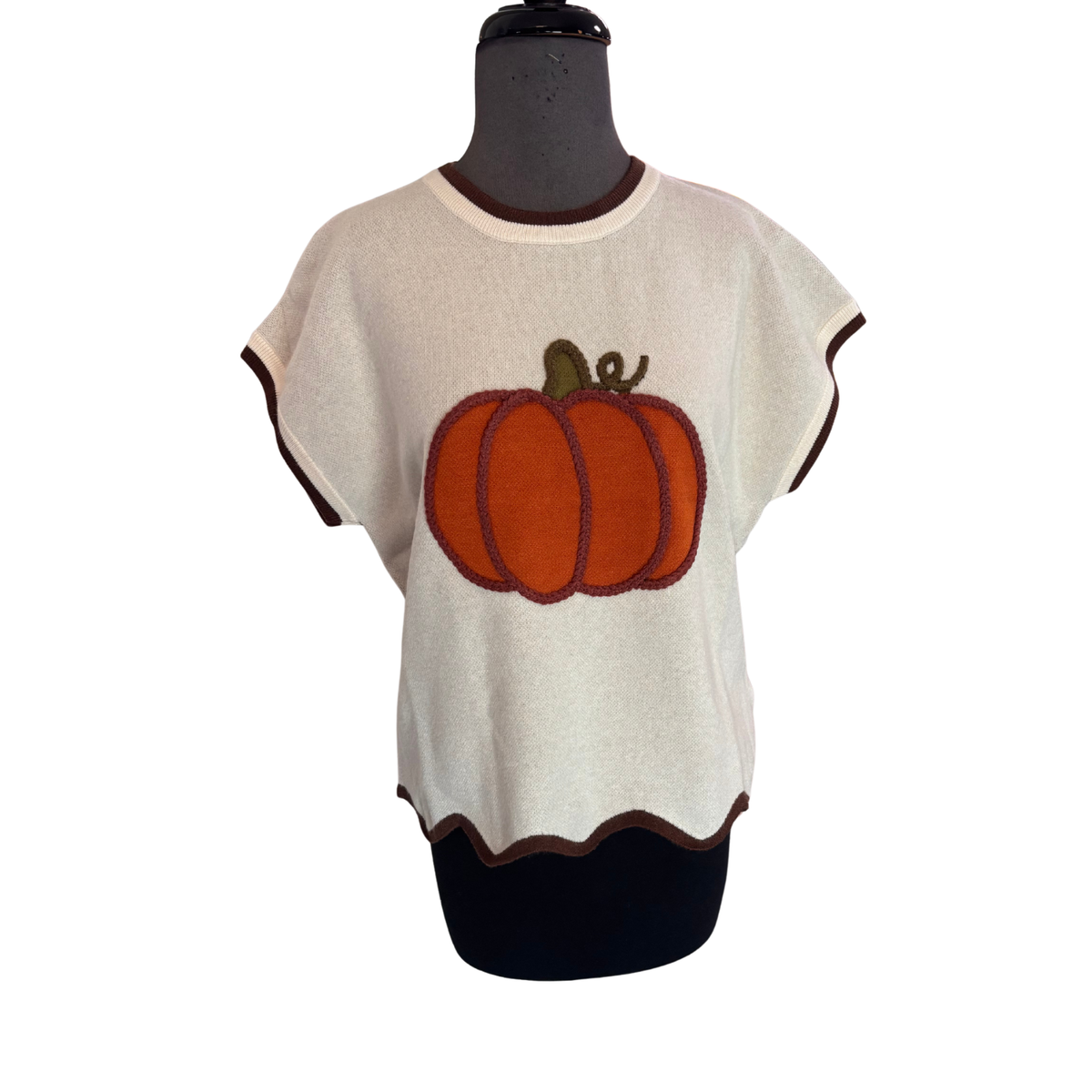 Soft cream-colored comfort meets playful style with this Drop Shoulder Pumpkin Sweater by She+Sky. The relaxed drop shoulder silhouette creates an effortless, oversized fit perfect for layering or wearing solo. Short sleeves pair with a charming scallop hem detail that adds feminine movement and visual interest to this wardrobe staple.