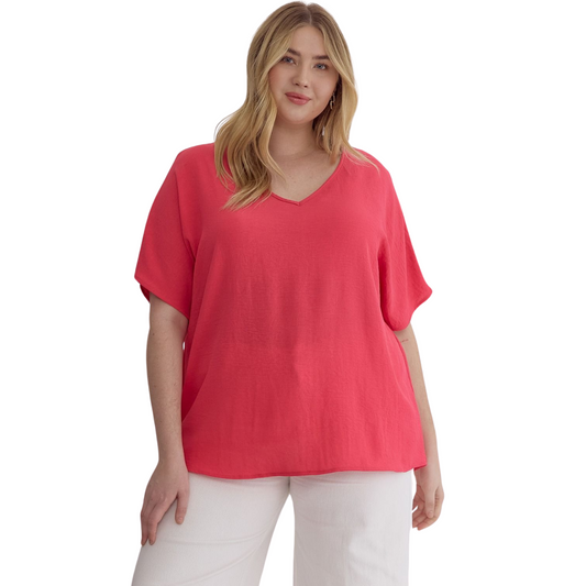 Expertly designed for plus size wear, this Solid V-Neck Top offers both style and comfort. The v-neck design flatters curves and the short sleeves provide a cool and breezy feel. Available in a punch color, it adds a pop of color to any outfit.