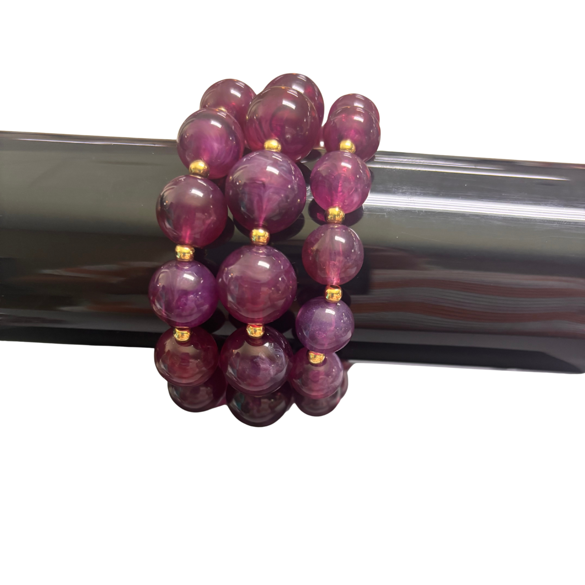 Elevate your wrist with this stunning Large Beaded Bracelet from Perdido Gems. Crafted with vibrant purple beads and gleaming gold accents, this piece combines bold color with sophisticated metallic details. The stretchy design ensures a comfortable, adjustable fit for any wrist size. Perfect for layering or wearing solo, this bracelet adds an instant pop of elegance to any outfit.