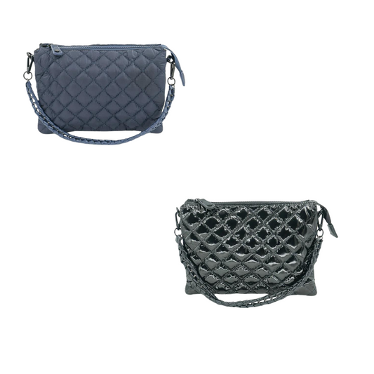 The Quilted Puffer Bag, available in black patent or navy, is a small purse designed by BC Bags. Its quilted exterior adds a touch of elegance while its puffer design provides durability. This compact bag is perfect for carrying essentials and is a stylish addition to any outfit.