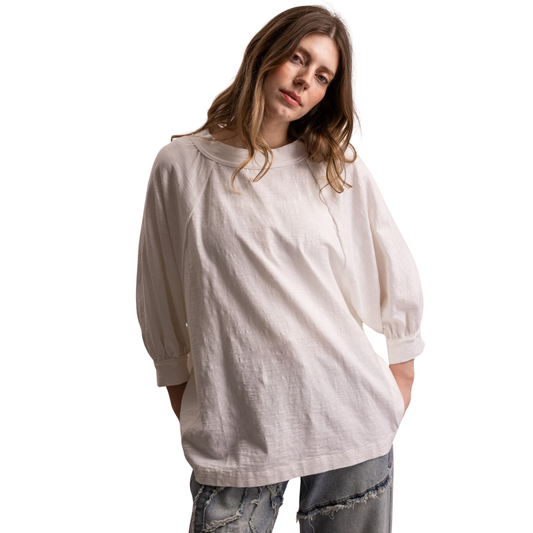 Elevate your everyday wardrobe with this oversized raglan top from Blue Velvet. Crafted in a soft off-white hue, the relaxed silhouette pairs effortlessly with jeans, skirts, or joggers. The 3/4 length sleeves offer versatile layering potential while maintaining a comfortable, laid-back aesthetic. Perfect for casual outings, weekend lounging, or creating an understated, polished look. A wardrobe essential that transitions seamlessly from season to season.