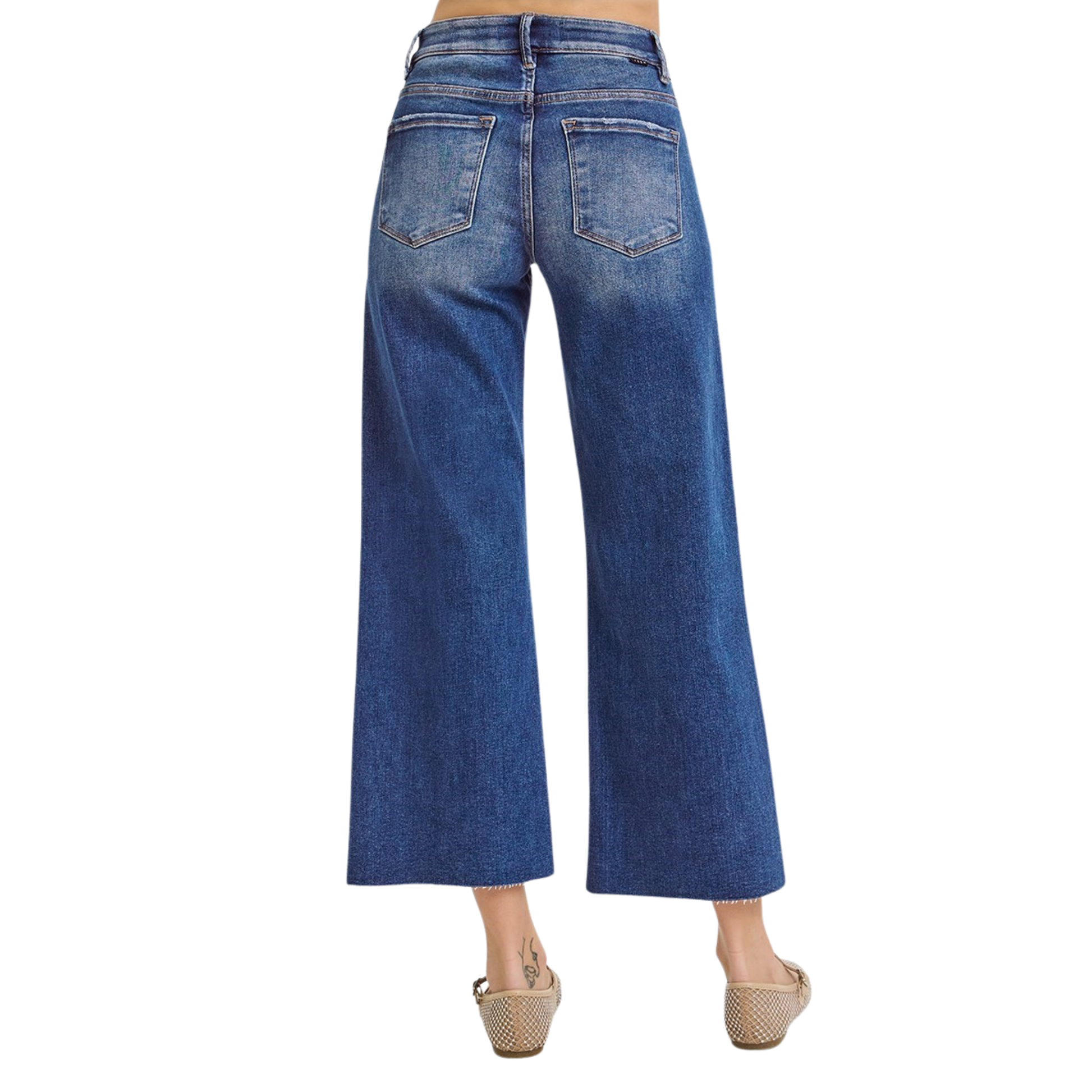 Elevate your casual wardrobe with these Mid Rise Cropped Jeans from Risen. Featuring a flattering mid-rise cut and cropped length, these jeans offer a modern silhouette that pairs effortlessly with sneakers or heels. The raw hem adds an edgy, on-trend finish, while the elastic waistband ensures all-day comfort and flexibility. Crafted in a rich dark wash, they're versatile enough for everyday wear or dressed-up occasions. A wardrobe essential that combines style and comfort.