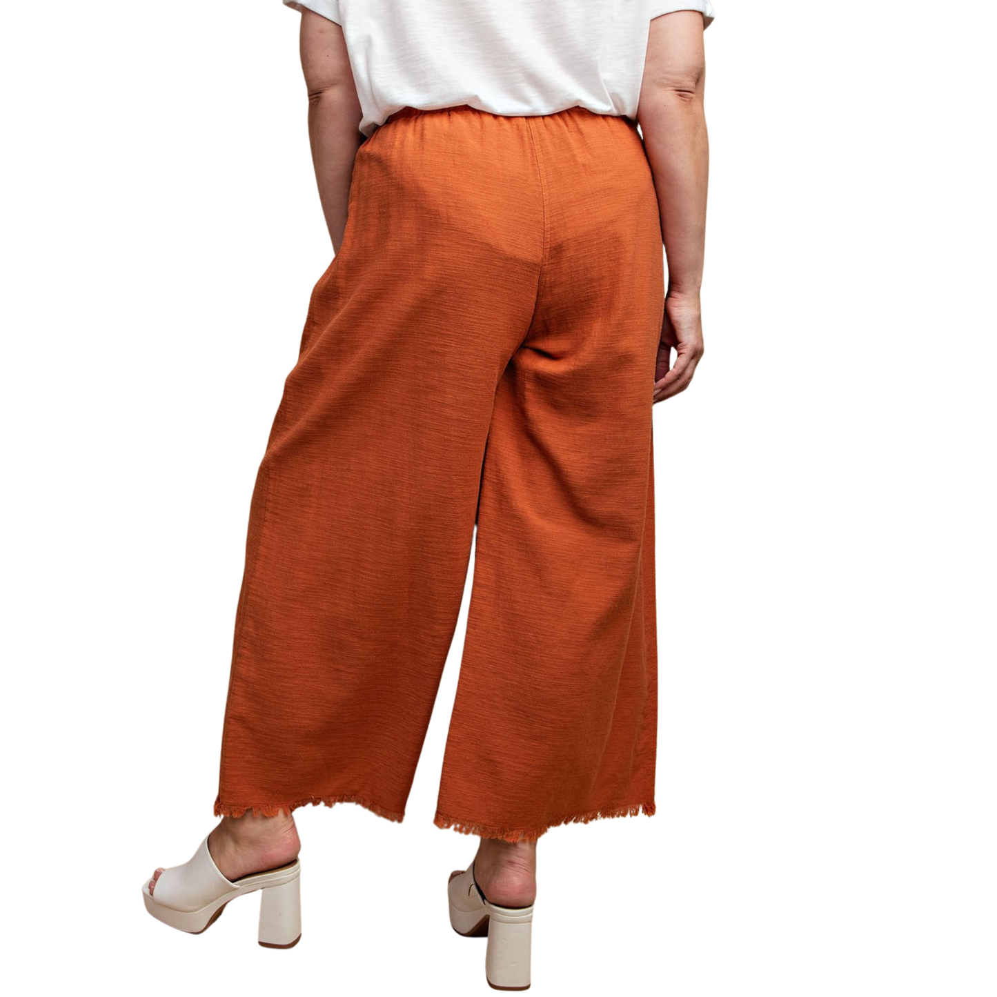 Elevate your wardrobe with these GiGio Frayed Wide Leg Pants in a rich red clay hue. Designed for plus-size figures, these pants offer a flattering silhouette with a relaxed wide-leg cut that moves beautifully. The frayed hem adds an effortless, on-trend detail, while functional pockets keep your essentials close. Perfect for casual outings or dressed-up occasions, this versatile piece combines comfort and style.