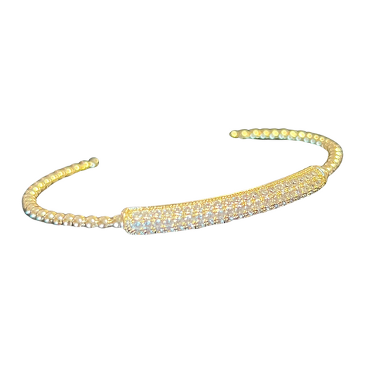 This Rhinestone Bar Bangle is an intricate and stylish accessory you'll reach for again and again. Crafted of gold beads and featuring a dainty rhinestone bar accent, this cuff bangle adds a touch of sparkle to any outfit.