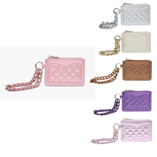 Meet Rhodes, the sparkling addition to our quilted collection this year! With her bold hues and acrylic wristlet strap, Rhodes adds pizzazz to any ensemble effortlessly. Featuring a top zipper pocket and quilted front pocket, she's as functional as she is stylish. Crafted from vegan leather, Rhodes is not only fashionable but also a sustainable choice for the environmentally conscious individual.