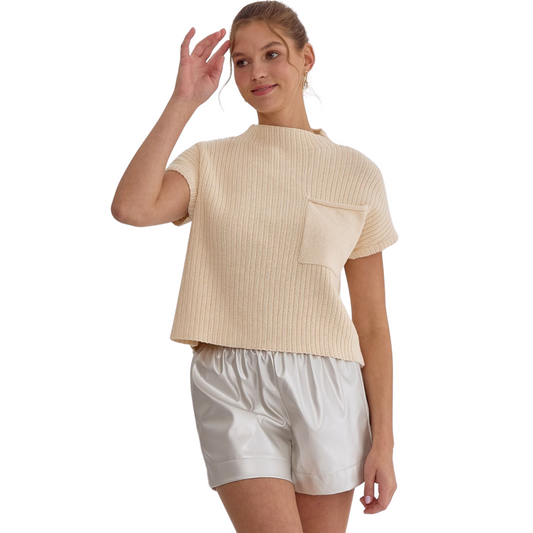 Expertly crafted with a ribbed texture and raw hem, this natural or off white cropped top features a convenient pocket for added functionality. Its timeless design allows for effortless style, making it a versatile addition to any wardrobe. Elevate your look with this must-have piece.