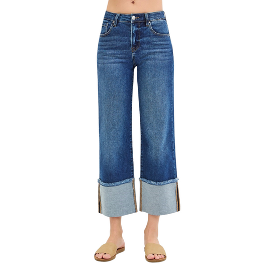 These Risen brand Mid Rise Cropped Wide Cuffed Jeans feature a dark wash and a wide leg with a wide cuff hem. Perfect for a trendy and stylish look, these jeans provide a comfortable fit and a fashionable edge. Upgrade your wardrobe with these must-have cropped jeans.